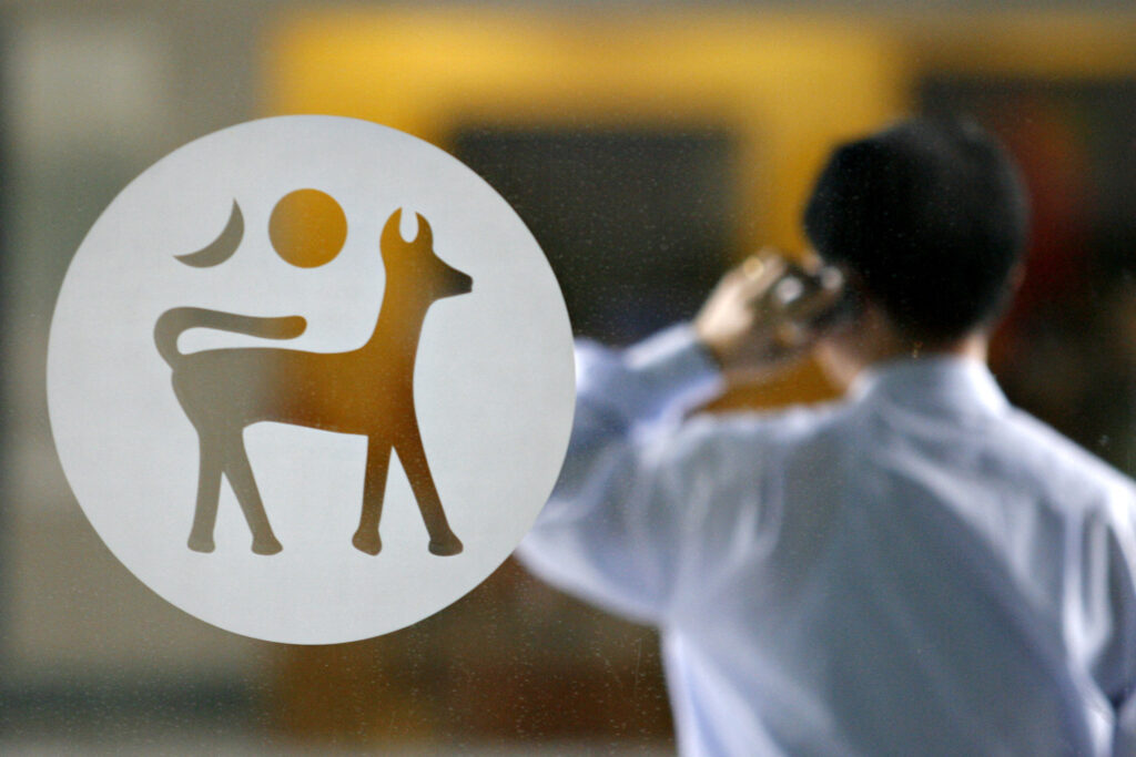 An employee talks on his mobile phone outside the lobby of Bank Negara.