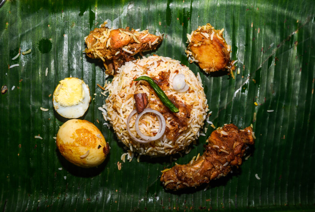 Biryani, a popular mixed rice dish from India, made with Indian spices, rice, and meat, with variations including eggs and vegetables like fried potatoes. Similar dishes are also made in countries like Iran, Iraq, Myanmar, Thailand, and Malaysia.