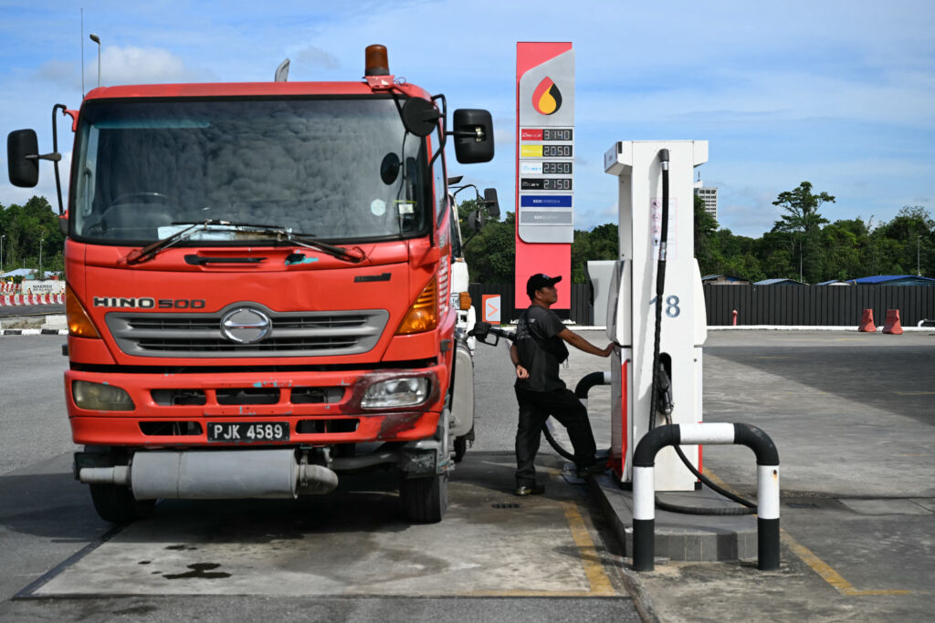 A man fills diesel in a lorry at a Petroleum Sarawak Berhad station on 20 June, 2025.