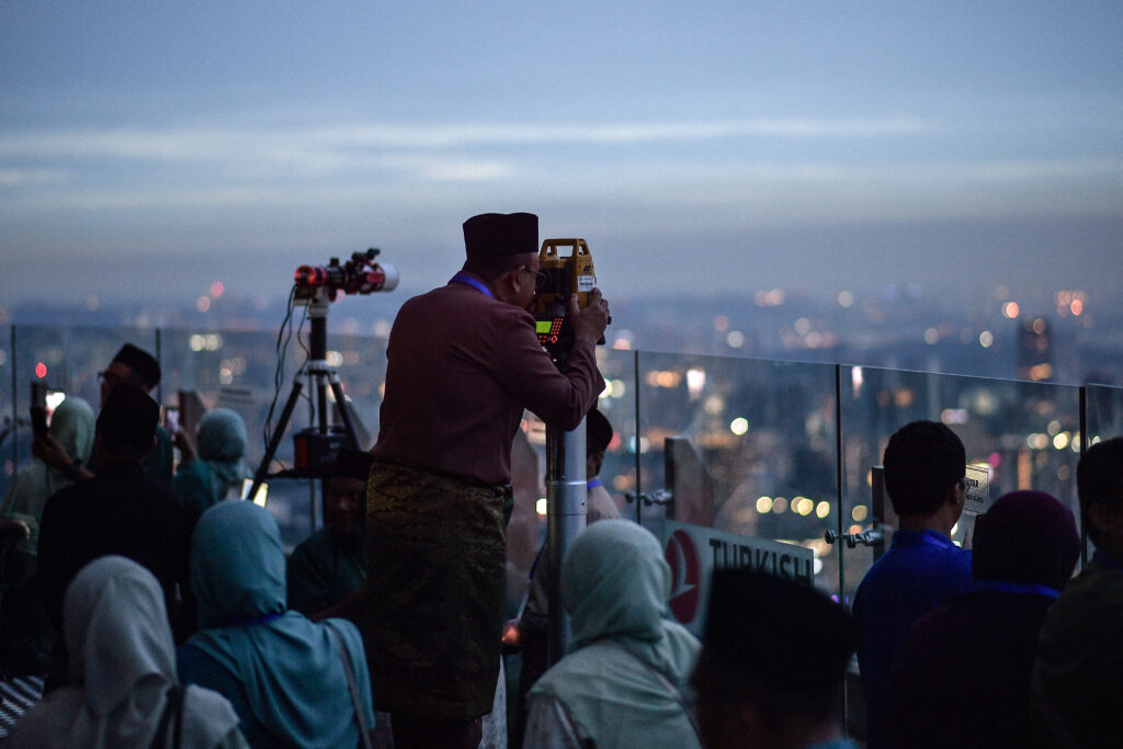 Malaysia's religious department member uses a telescope to perform 'Rukyah', the sighting of the new moon to mark the start of Islam's holy month of Ramadan in Kuala Lumpur on 17 February.