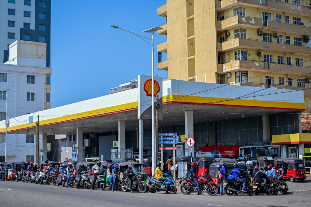 Motorists wait in a queue to refuel their vehicles at a filling station in Wellawatte on the outskirts of Colombo on March 16, 2026. Sri Lanka announced a shorter work week to conserve its scarce fuel reserves as it prepares for a prolonged war in the Middle East, officials said on 16 March.