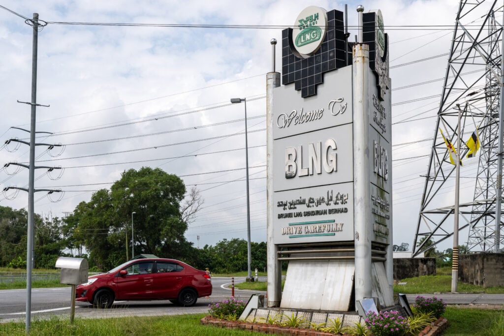 A car drives past the logo of Brunei Liquefied Natural Gas (BLNG) company in Kuala Belait district in Brunei