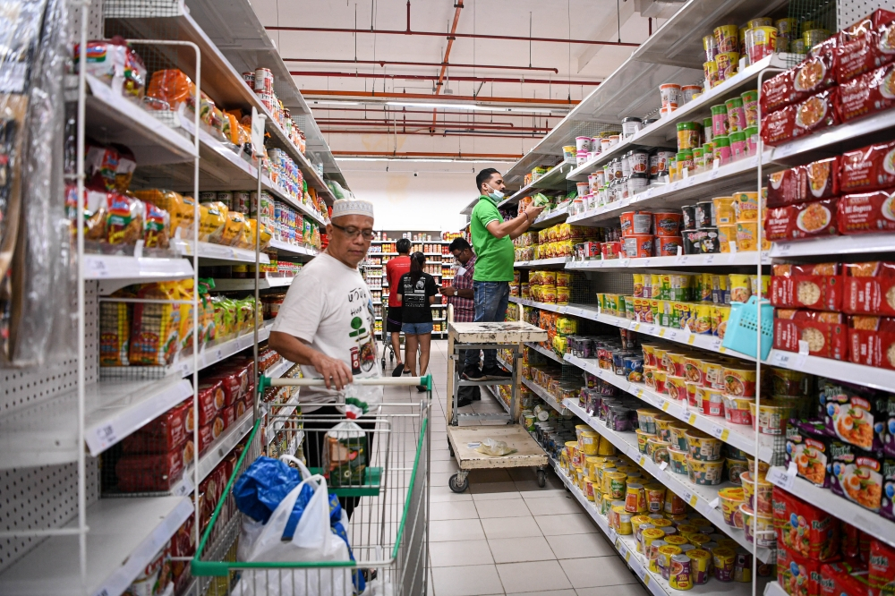 Members of the public shop at the Econsave supermarket in Setapak Sentral, Kuala Lumpur.
