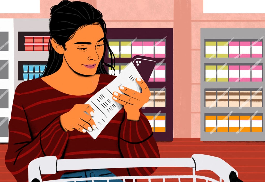 A woman examines a shopping receipt.