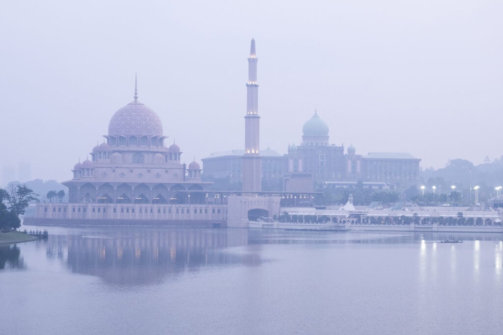 This photo shows the Putra Mosque (L) and Malaysia's Prime Minister's Office covered in haze in Putrajaya on 14 August, as authorities in Malaysia warned of high levels of air pollution from regional wildfires.