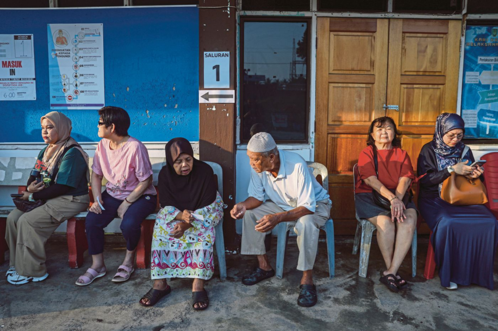 Malaysians queuing up according to their saluran on election day.